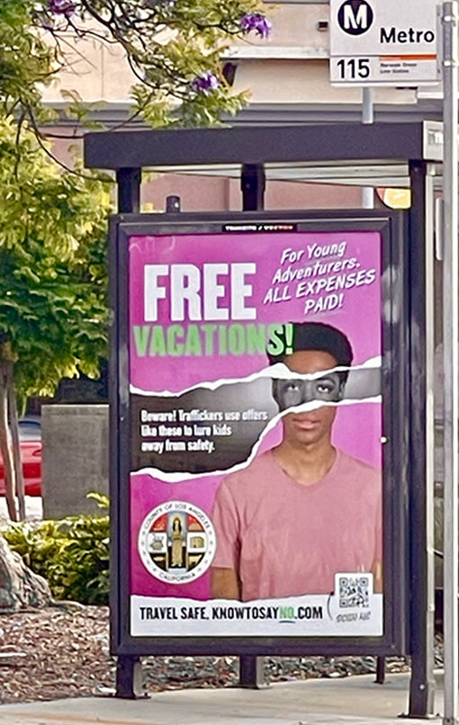 African American teen post at a bus shelter