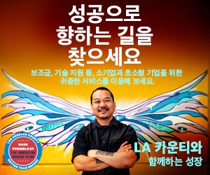 Korean man with angel wings on wall behind him
